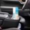 Tumbler in car cup holder with beach and water scene visible as well as custom added name.